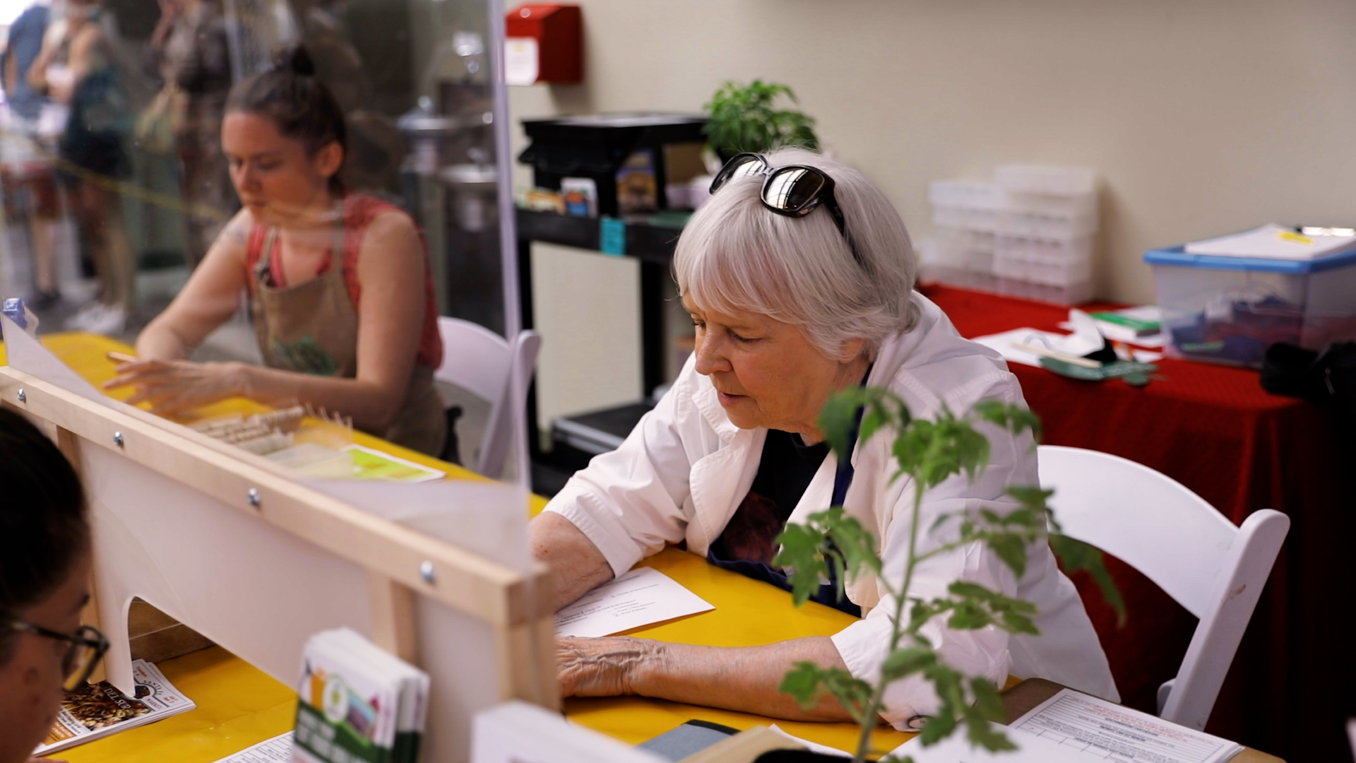 Mary Dixon of Green Tractor Farm Reads to Children at the Santa Fe Public Library's Southside Branch with the Assistance of her grandson Major, who was visiting from New York City. Photo: Janice Mayer