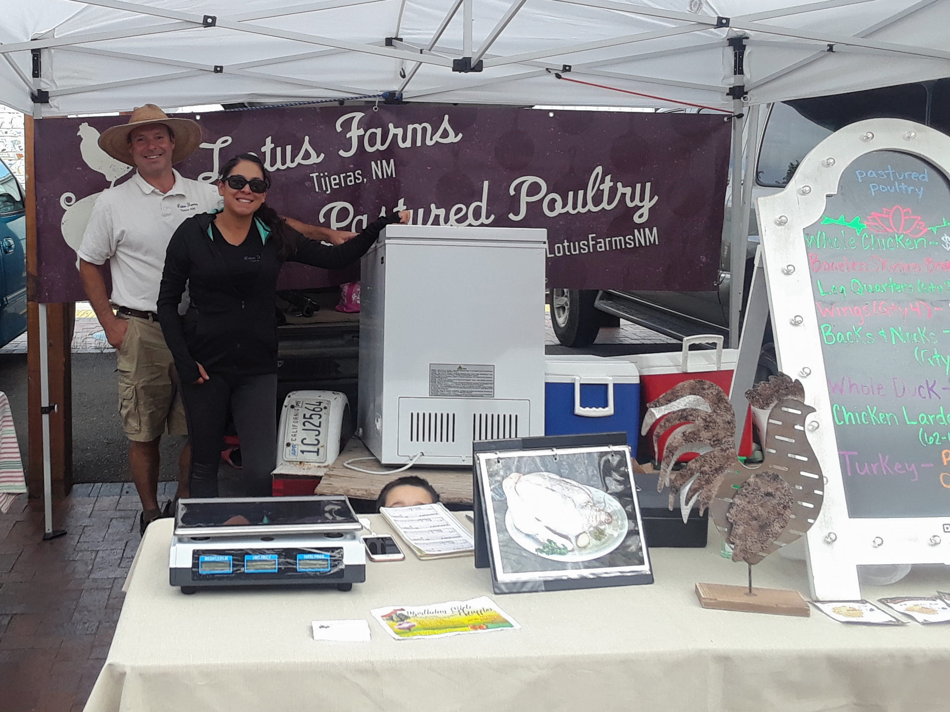 Representative Teresa Leger Fernández talking with Santa Fe Farmers' Market Institute staff.
